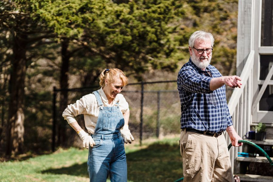 Older couple gardening together in the sunshine